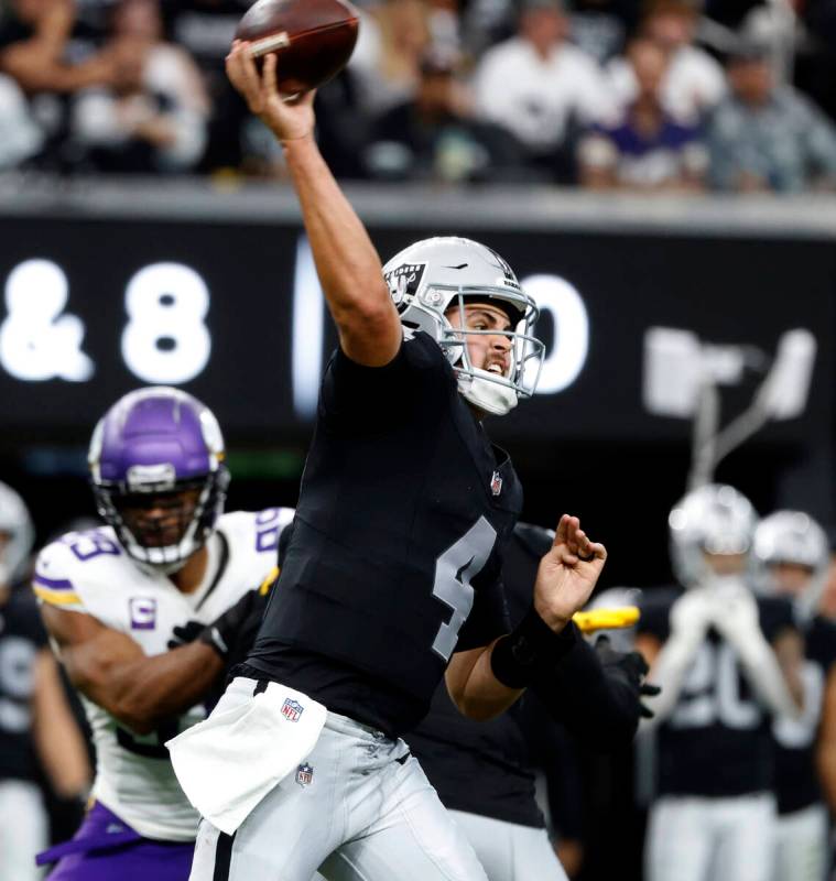Raiders quarterback Aidan O'Connell (4) throws a pass during the first half of an NFL football ...
