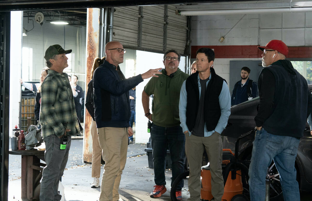 Director Simon Cellan Jones is shown working on Mark Wahlburg's latest film, "The Family Plan," ...