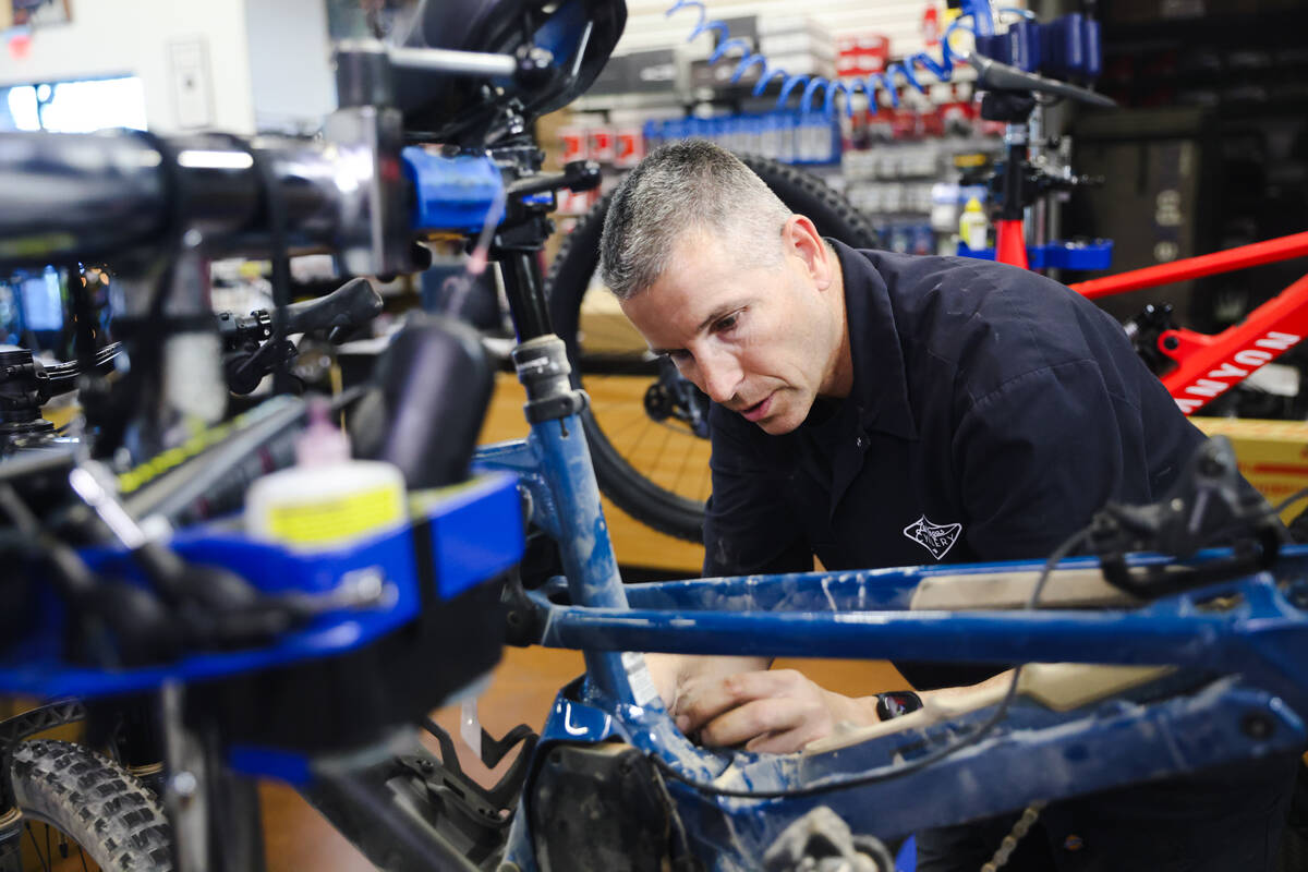 Jason Miller, assistant manager, fixes a bike at Las Vegas Cyclery in Las Vegas, Monday, Dec. 1 ...