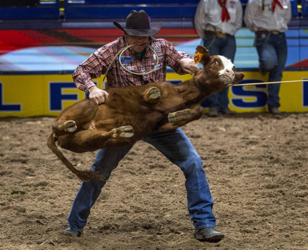 Caleb Smidt takes first place in Tie-Down Roping during day 5 action of the NFR at the Thomas & ...