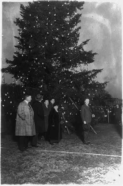 U.S. President Calvin Coolidge (right) turned on the electric lights adorning the first Nationa ...