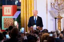 President Joe Biden speaks at a Hanukkah reception in the East Room of the White House in Washi ...