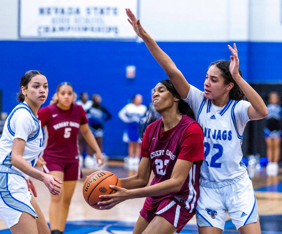 Desert Oasis forward Brooklyn Scurry (23) battles underneath the basket for a shot defended wel ...