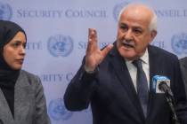 Palestinian United Nations Ambassador Riyad Mansour, right, speaks during a press conference ah ...