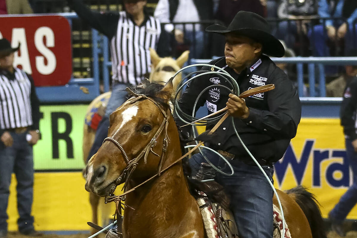 Erich Rogers takes part in the team roping competition in the tenth go-round of the National Fi ...