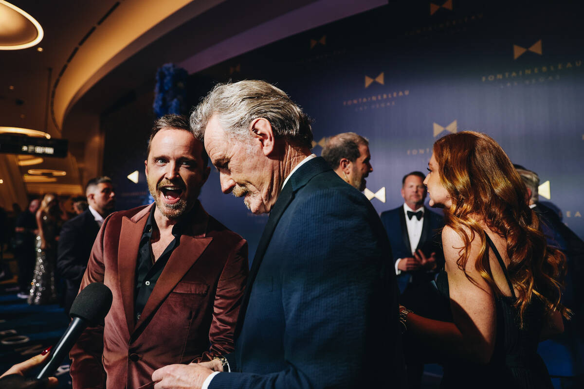 Aaron Paul, left, and Bryan Cranston answer questions from reporters at the Fontainebleau &#x2 ...