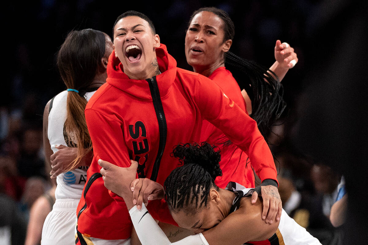 Las Vegas Aces guard Kierstan Bell, left, embraces forward A'ja Wilson, right, as they win Game ...