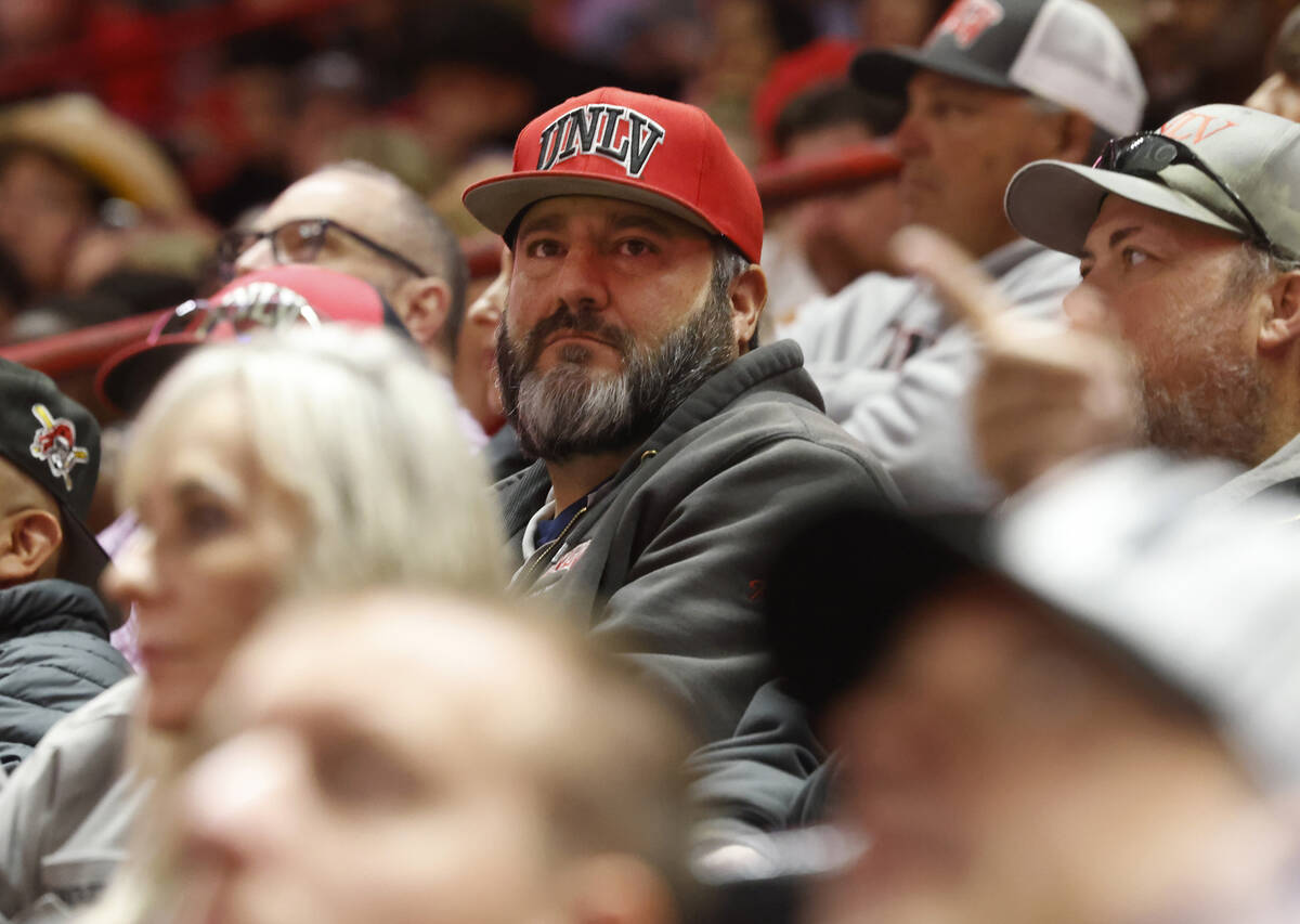 A man wearing a UNLV cap attends day six of the National Finals Rodeo at Thomas and Mack Center ...