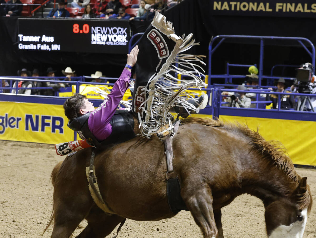 Tanner Aus holds on to his horse while he competes in bareback riding on day six of the Nationa ...