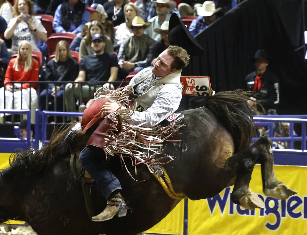 Dean Thompson holds on to his horse while he competes in bareback riding on day six of the Nati ...