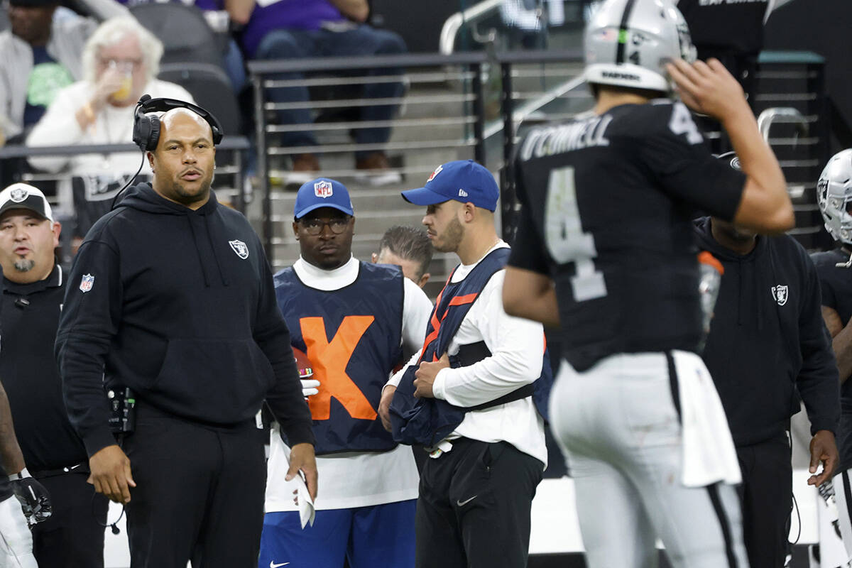 Raiders quarterback Aidan O'Connell (4) communicates with Interim Head Coach Antonio Pierce dur ...