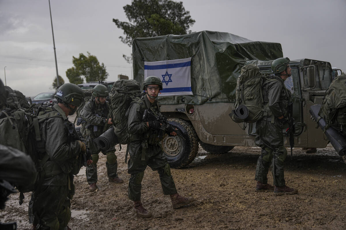 Israeli soldiers prepare to enter the Gaza Strip at a staging area near the Israeli-Gaza border ...