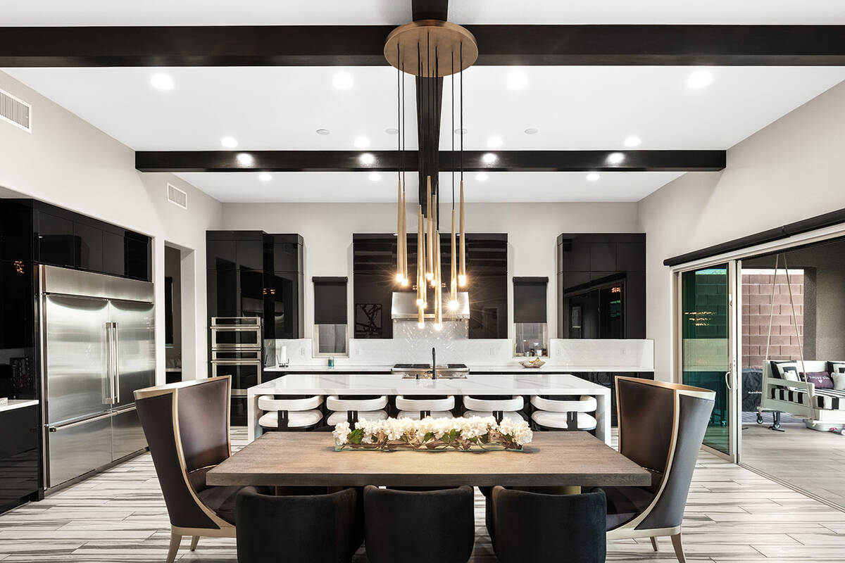 huntington & ellis The home features a chef’s kitchen with a 12.5-foot quartz waterfall islan ...