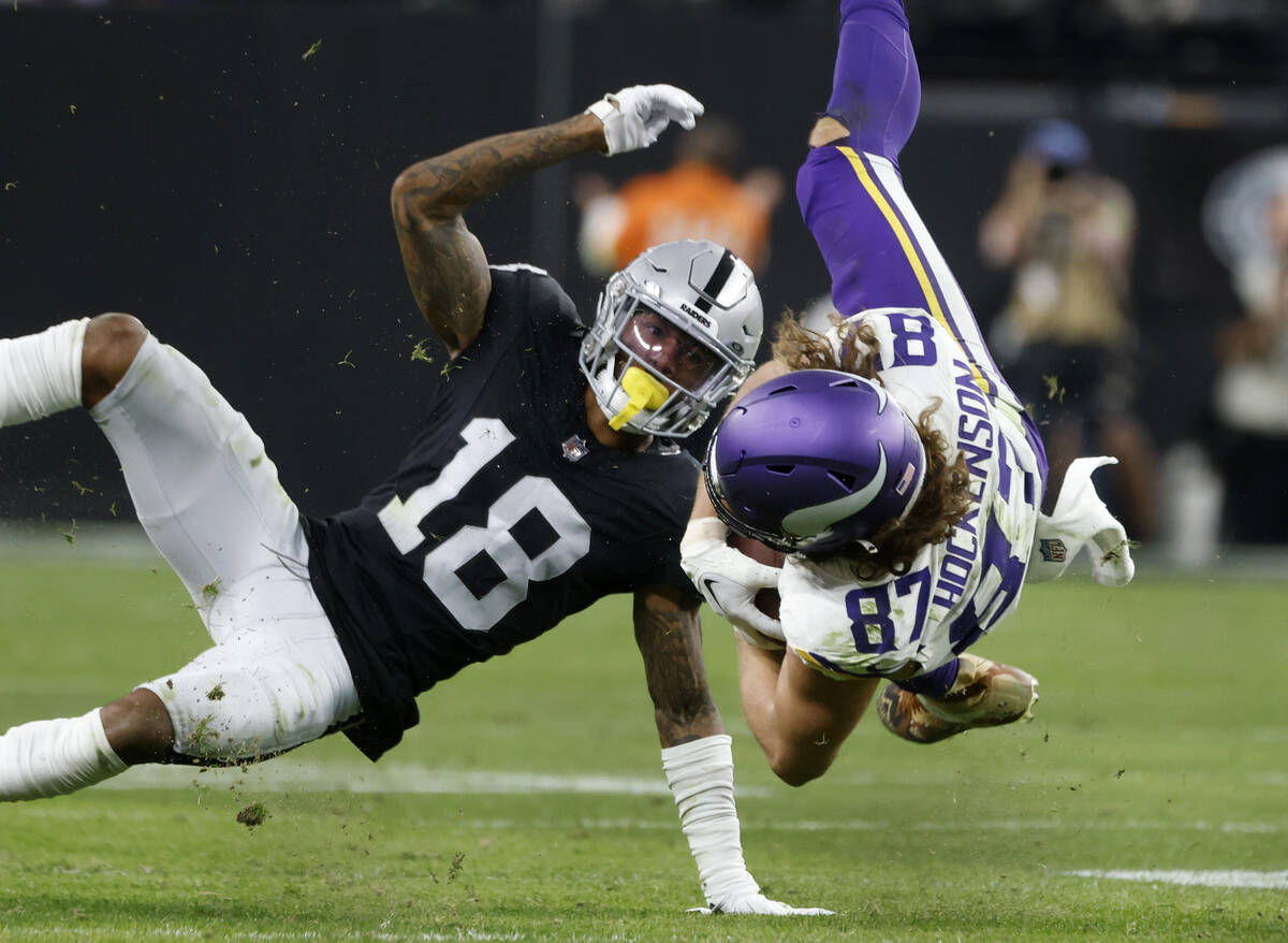 Minnesota Vikings tight end T.J. Hockenson (87) catches the ball in front of Raiders cornerback ...