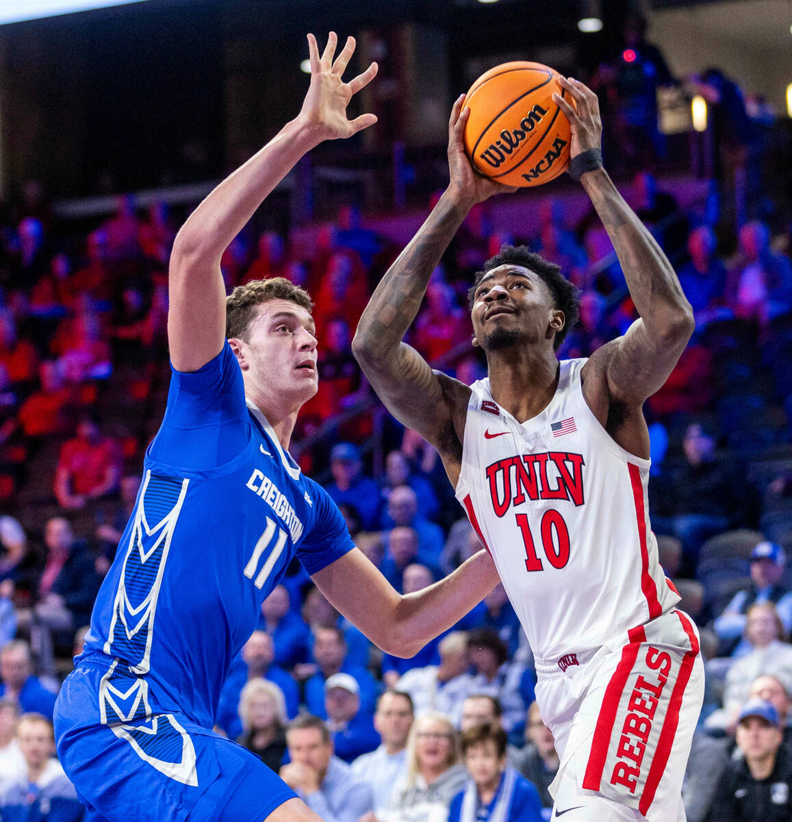 UNLV Rebels forward Kalib Boone (10) eyes the basket as Creighton Bluejays center Ryan Kalkbren ...