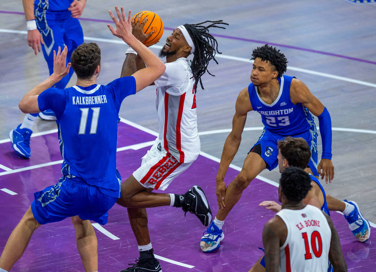 UNLV Rebels forward Keylan Boone (20) drives the lane against Creighton Bluejays center Ryan Ka ...