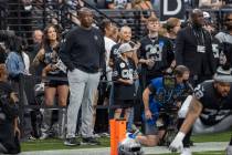 Raiders defensive coordinator Patrick Graham, left, watches team warm ups before an NFL game be ...