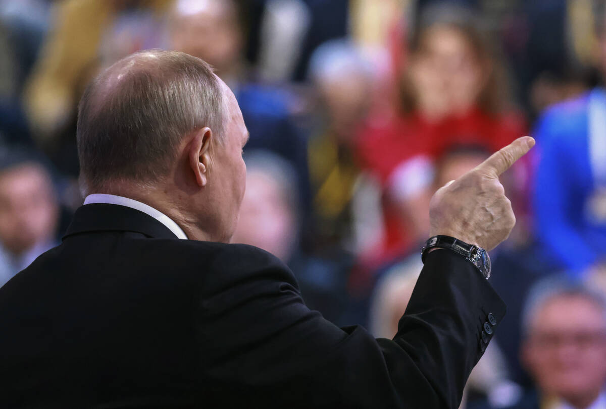 Russian President Vladimir Putin gestures during his annual news conference in Moscow, Russia, ...