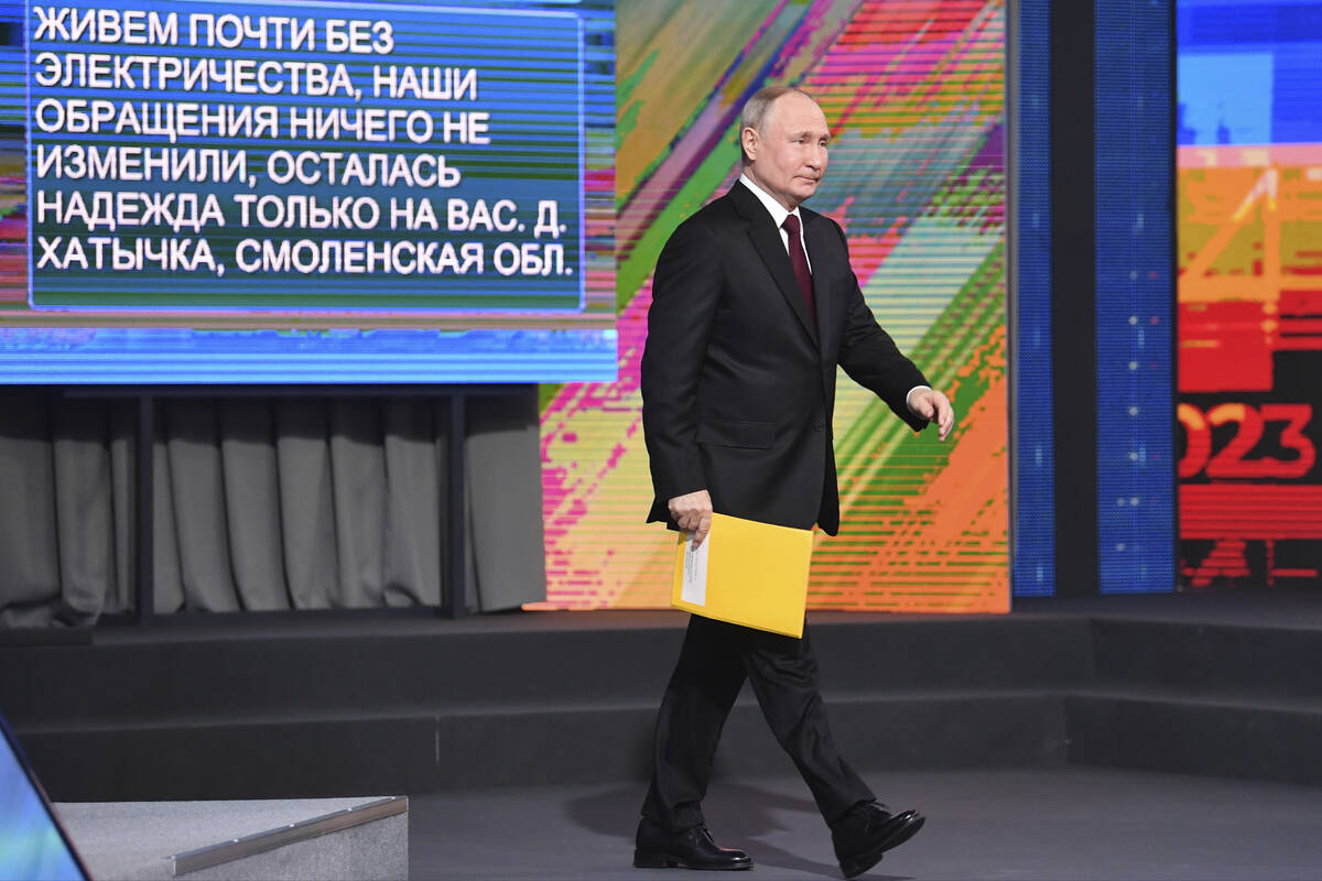 Russian President Vladimir Putin arrives to attend his annual news conference in Moscow, Russia ...