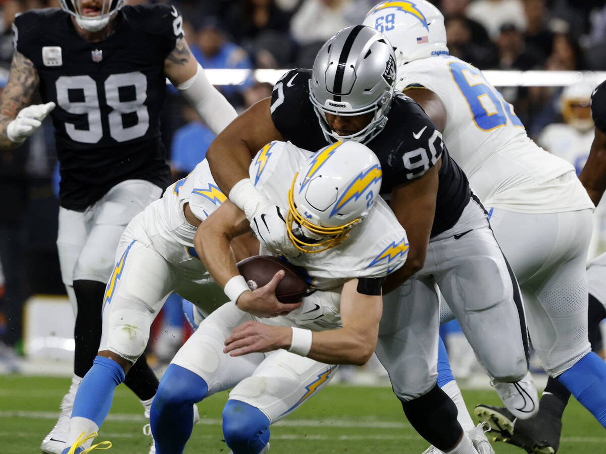 Raiders defensive tackle Jerry Tillery (90) takes down Los Angeles Chargers  quarterback Easton …