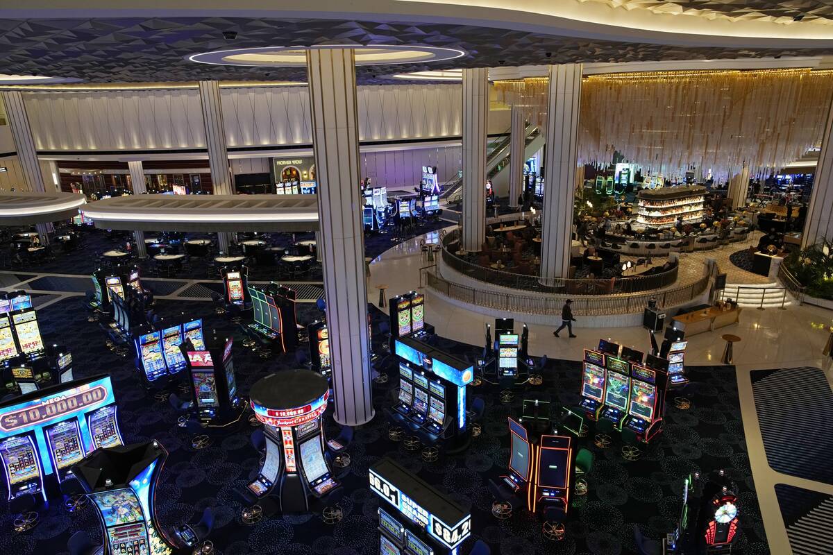 People walk through the casino area at the Fontainebleau Las Vegas hotel-casino Tuesday, Dec. 1 ...