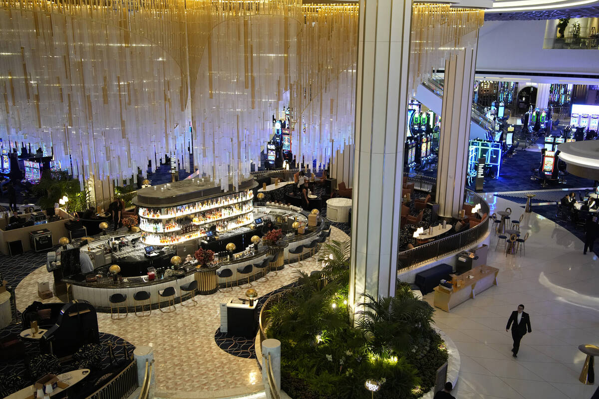 People walk by a bar in the casino at the Fontainebleau Las Vegas hotel-casino Tuesday, Dec. 12 ...