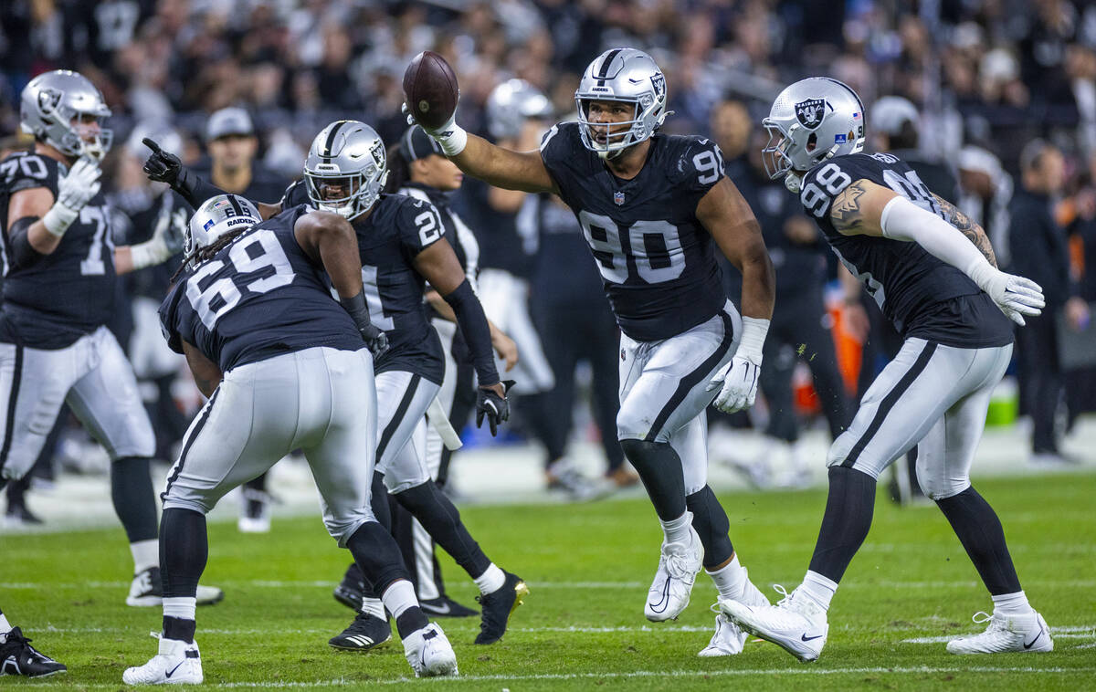 Raiders defensive tackle Jerry Tillery (90) celebrates a fumble recovery by the Los Angeles Cha ...