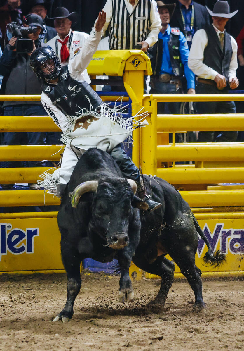 Trey Kimzey rides the bull during the National Finals Rodeo at the Thomas & Mack Center on ...