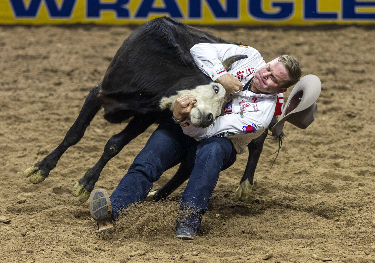 Dakota Eldridge works to take down his steer in Steer Wrestling during the final day action of ...