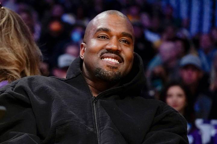 Kanye West watches the first half of an NBA basketball game between the Washington Wizards and ...