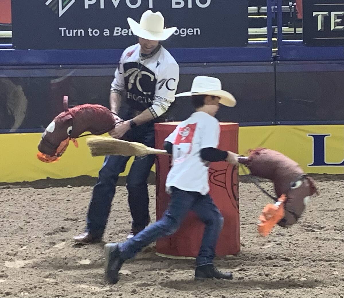 Caption: Wrangler NFR bullfighter Dusty Tuckness tries to keep up with Bronson Hart in mock bar ...