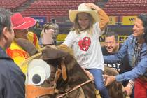Addysen Agasi is all smiles during her mock saddle bronc ride at Thursday's Wrangler NFR Except ...