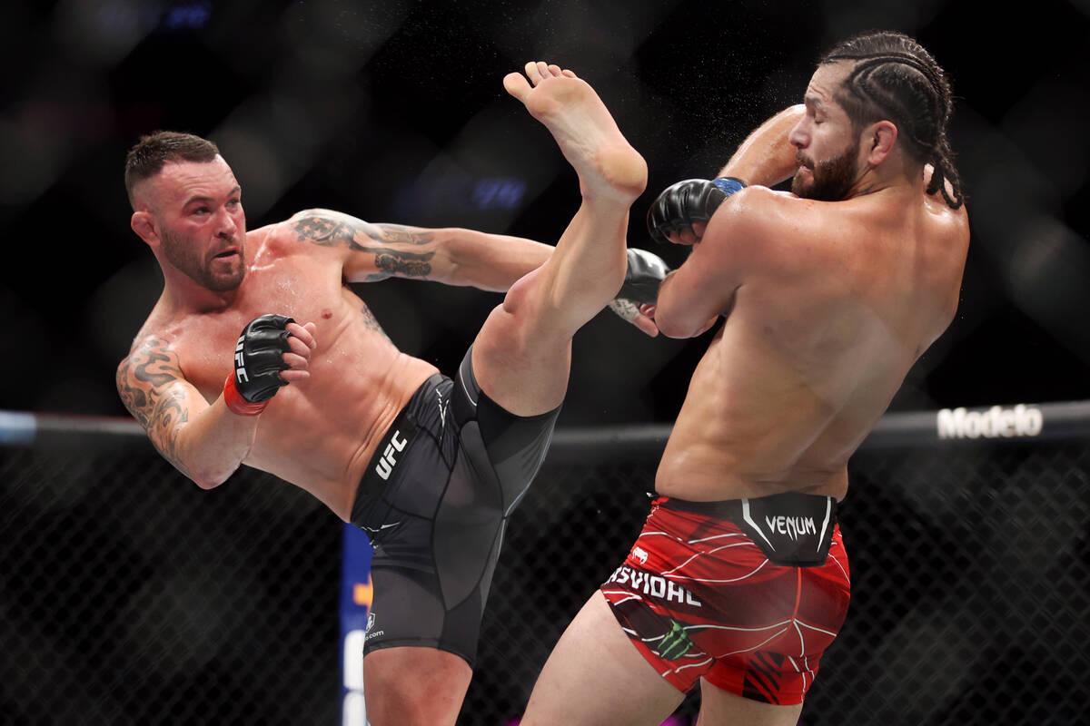 Jorge Masdival, right, moves away from a kick by Colby Covington in the third round of an UFC 2 ...