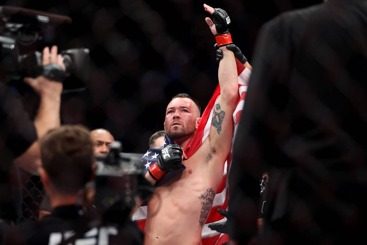 Colby Covington raises his arm in victory after his unanimous decision victory against Jorge Ma ...