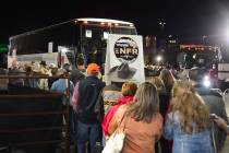 Wrangler NFR patrons load onto a bus in the Thomas & Mack Center parking lot, to head back to t ...