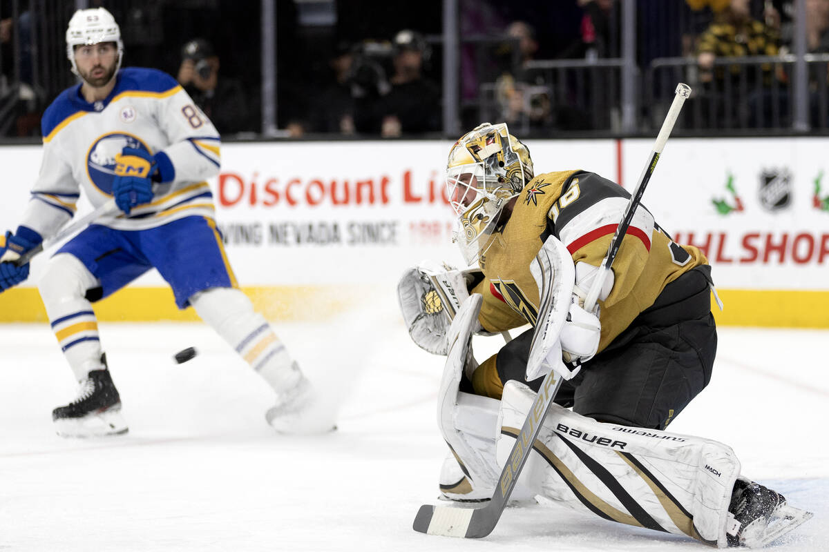 Golden Knights goaltender Logan Thompson (36) prepares to save the puck while Sabres right wing ...