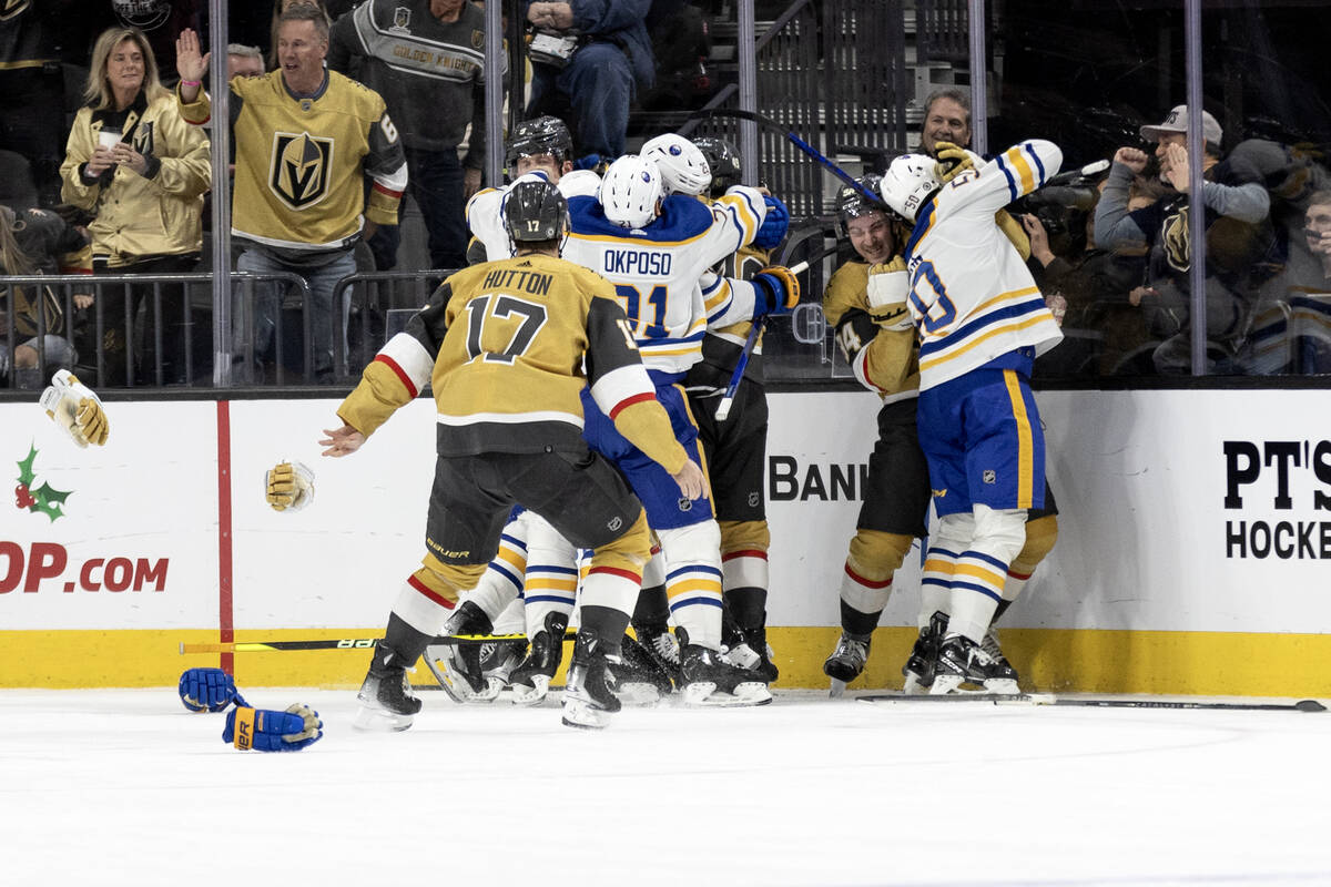 Gloves fly as the Golden Knights fight with the Sabres during the second period of an NHL hocke ...