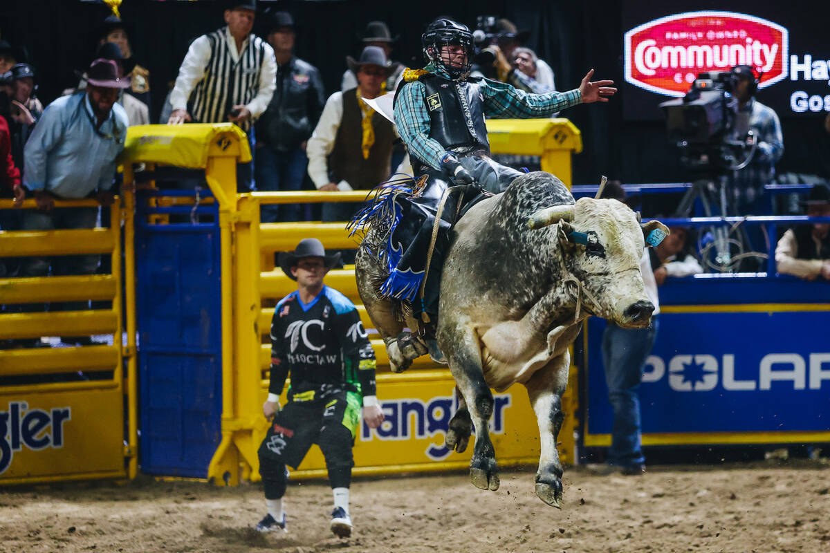 Jeff Askey rides the bull during day three of the National Finals Rodeo at the Thomas & Mac ...