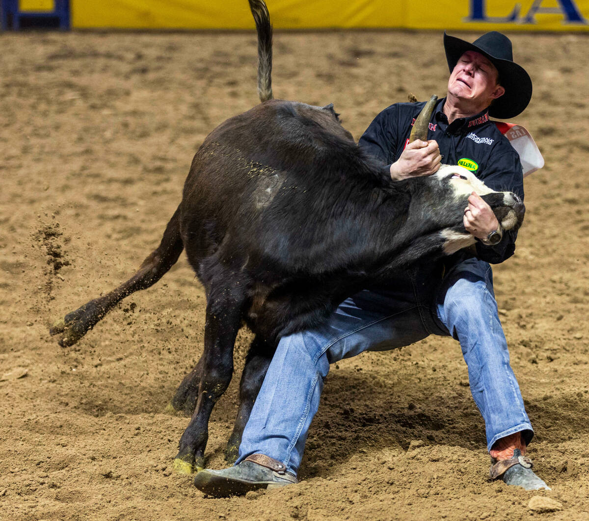 Ty Erickson struggles to take down his steer in Steer Wrestling during the final day action of ...