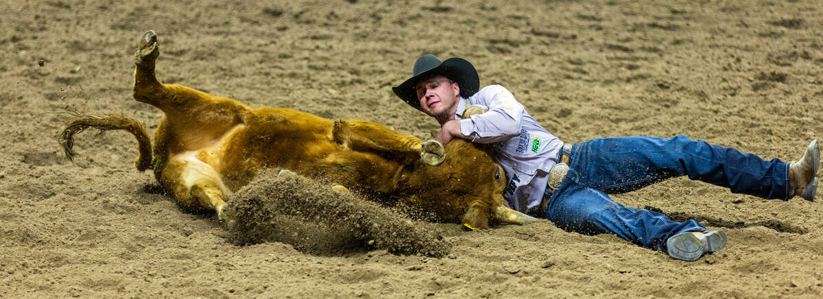 Bridger Anderson gets down his steer in Steer Wrestling during the final day action of the NFR ...