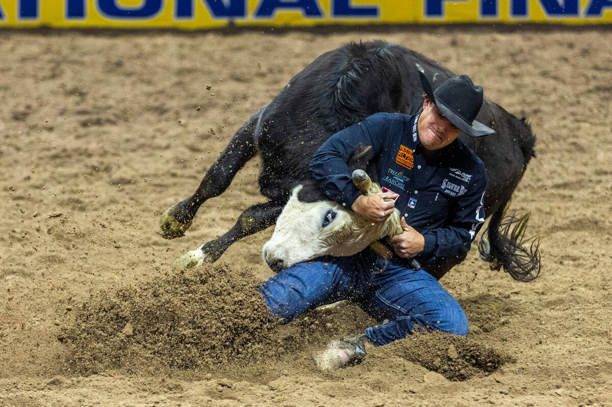 Dirk Tavenner struggles to take down his steer in Steer Wrestling during the final day action o ...