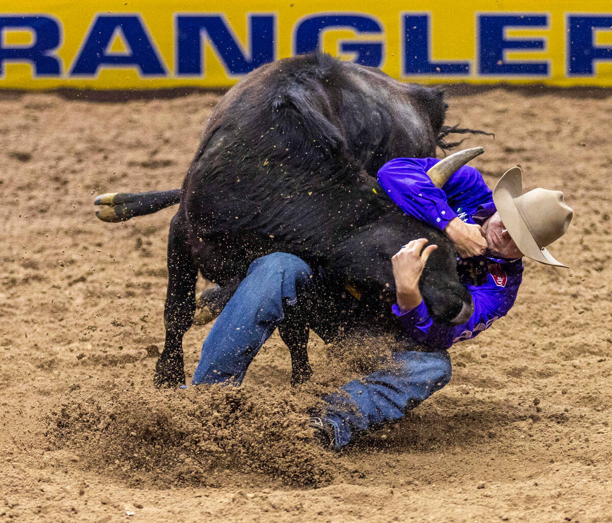 Tyler Waguespack works to take down his steer in Steer Wrestling during the final day action of ...