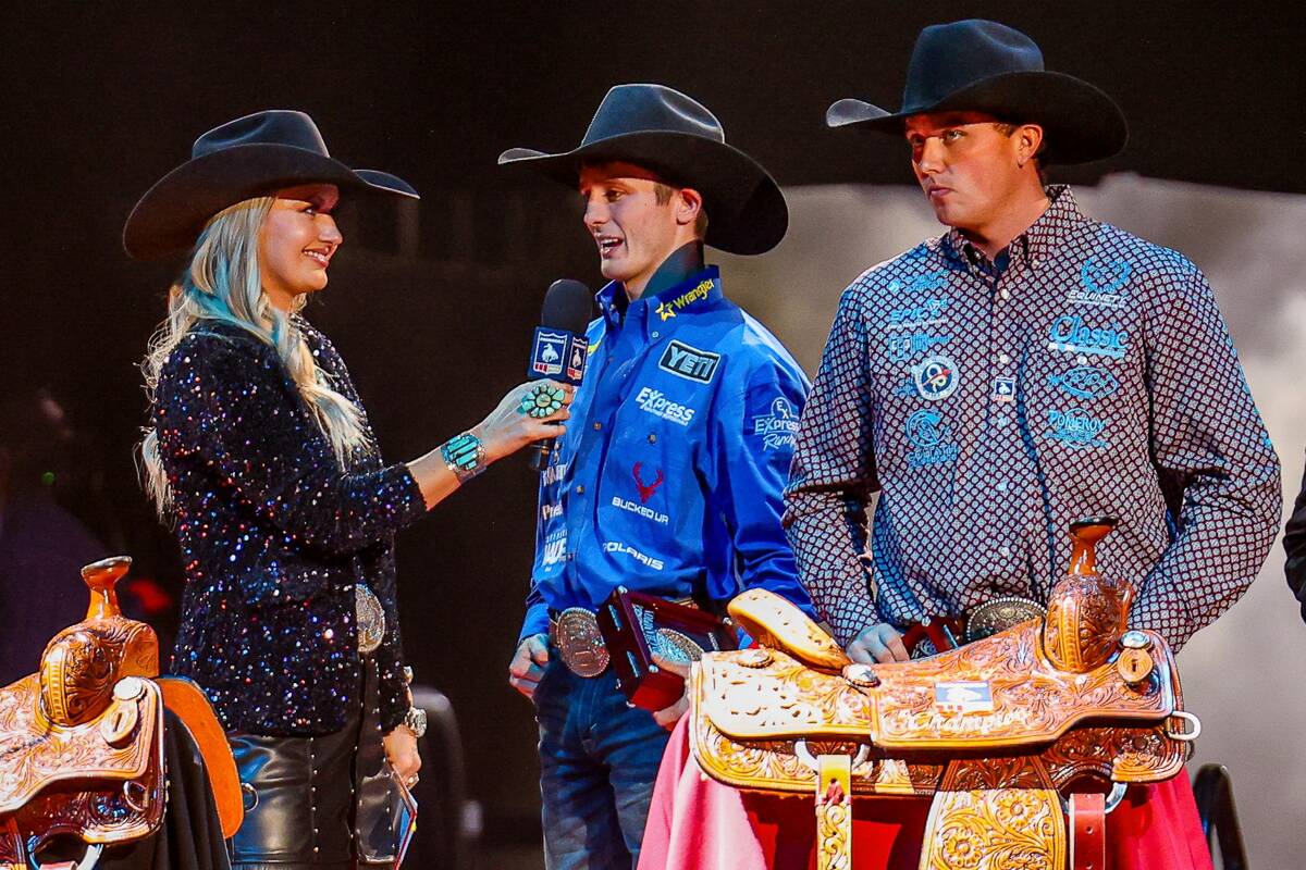 Stetson Wright, center, talks about winning a fifth straight all-around championship at the Nat ...