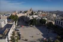 People walk in Manger Square, adjacent to the Church of the Nativity, traditionally believed to ...