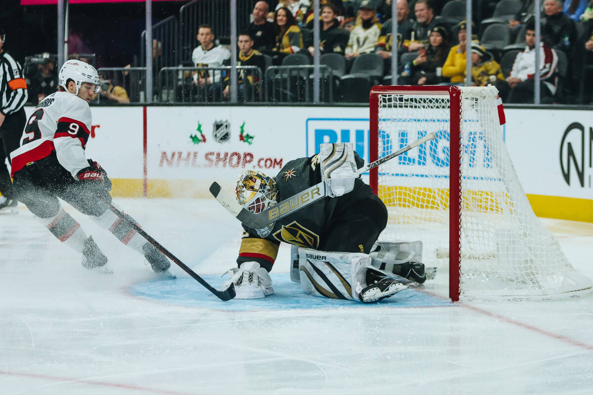 Golden Knights goaltender Logan Thompson (36) saves the puck from going into the net during a g ...