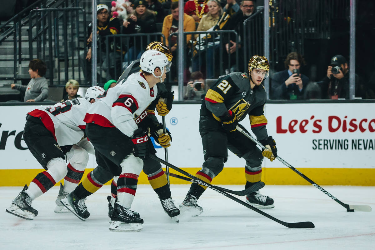 Golden Knights center Brett Howden (21) shuffles the puck down the ice as Ottawa Senators defen ...