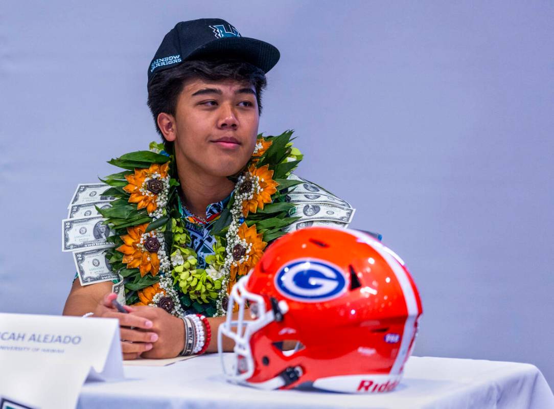 Bishop Gorman quarterback Micah Alejado listens to player introductions during a National Signi ...