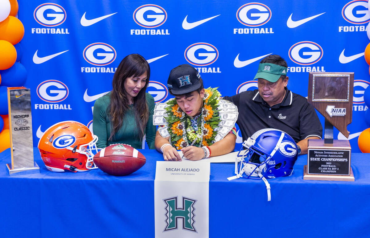 Bishop Gorman player Micah Alejado and family with a commitment letter to the University of Haw ...