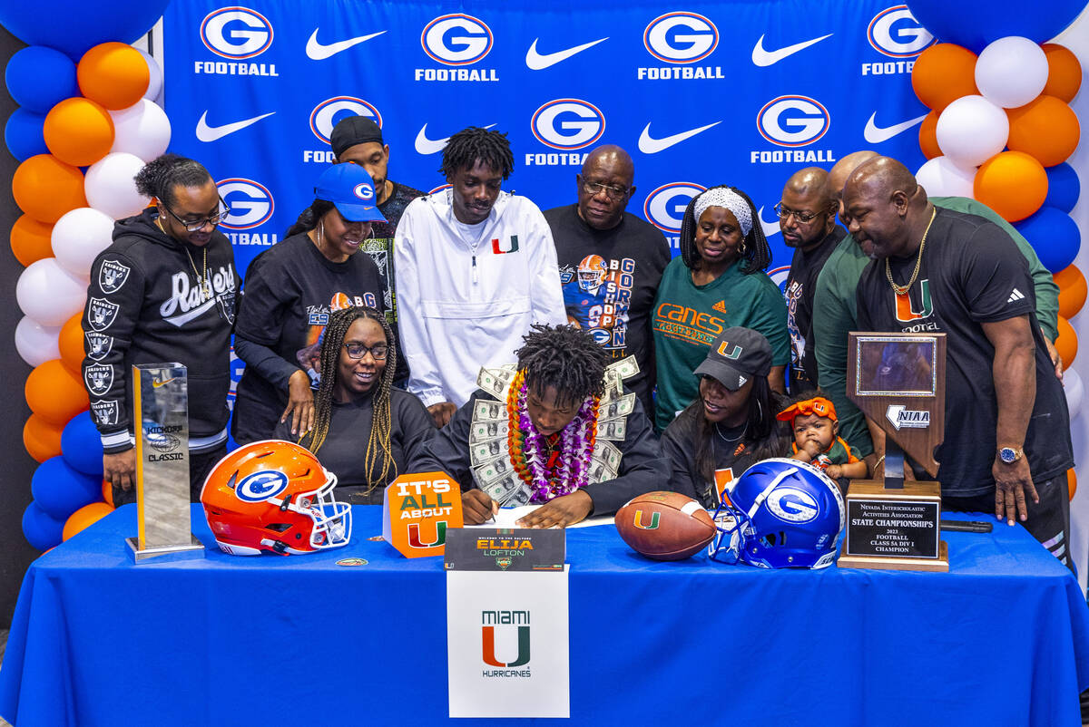 Bishop Gorman player Elijah Lofton and family with a commitment letter to the University of Mia ...
