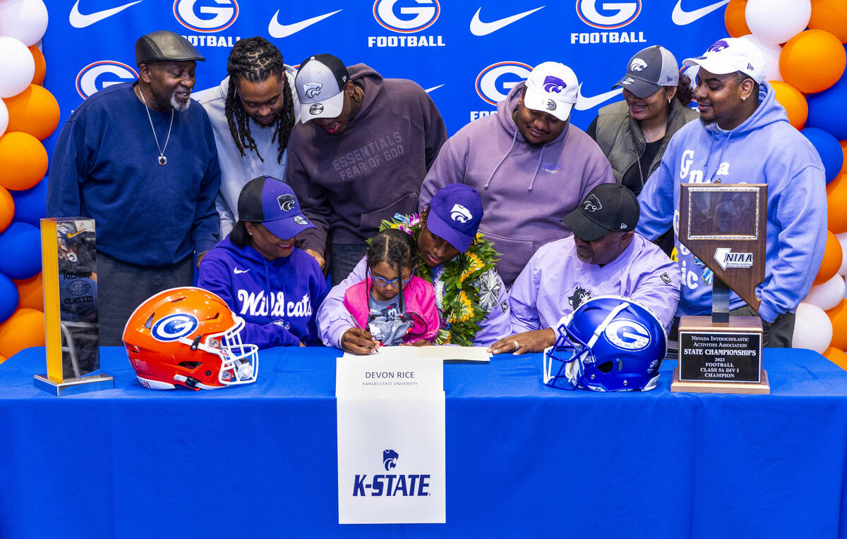 Bishop Gorman player DeVon Rice and family with a commitment letter to the Kansas State Univers ...